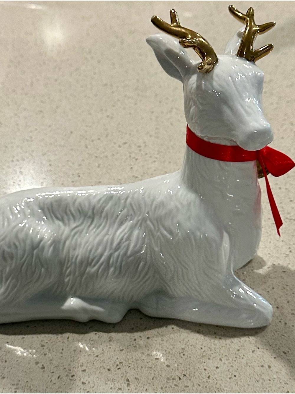 White Ceramic Reindeer Holiday Figurine with Gold Antlers and Red Ribbon